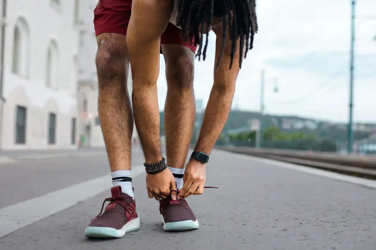 man tying a lace before 5k run