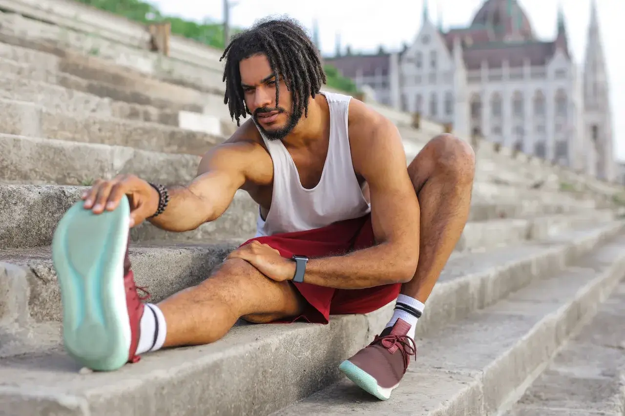 man stretching before 5k run